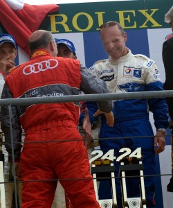 Olivier Quesnel get a congratulatory handshake from Audi boss Wolfgang Ullrich.